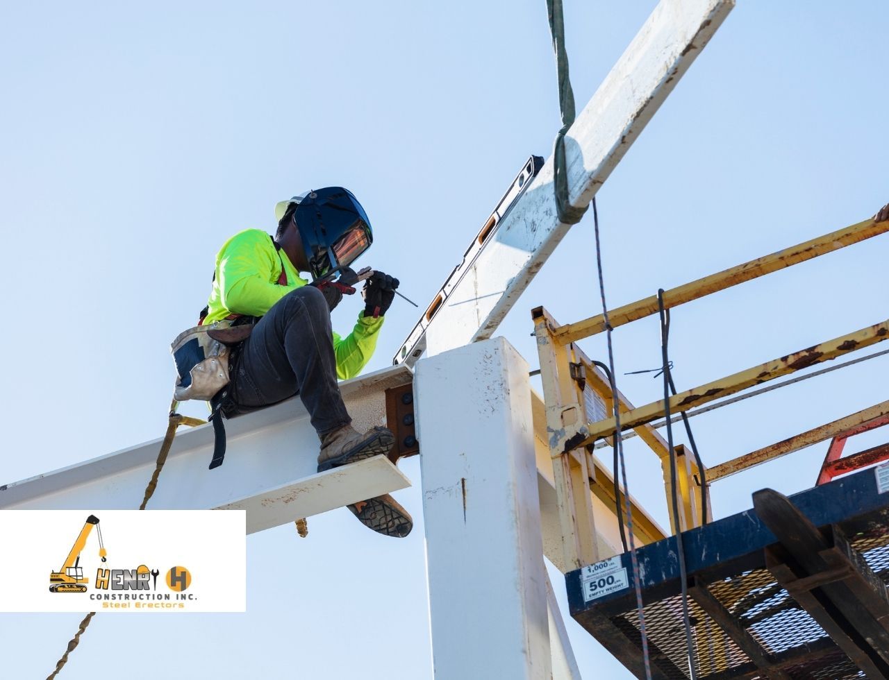 Worker using boom lift during steel installation