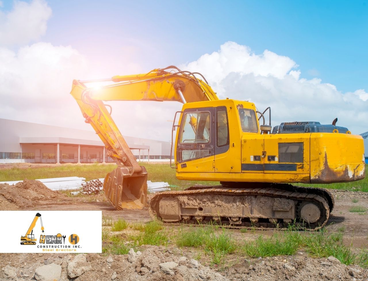 Excavator clearing land to prepare site for steel erection