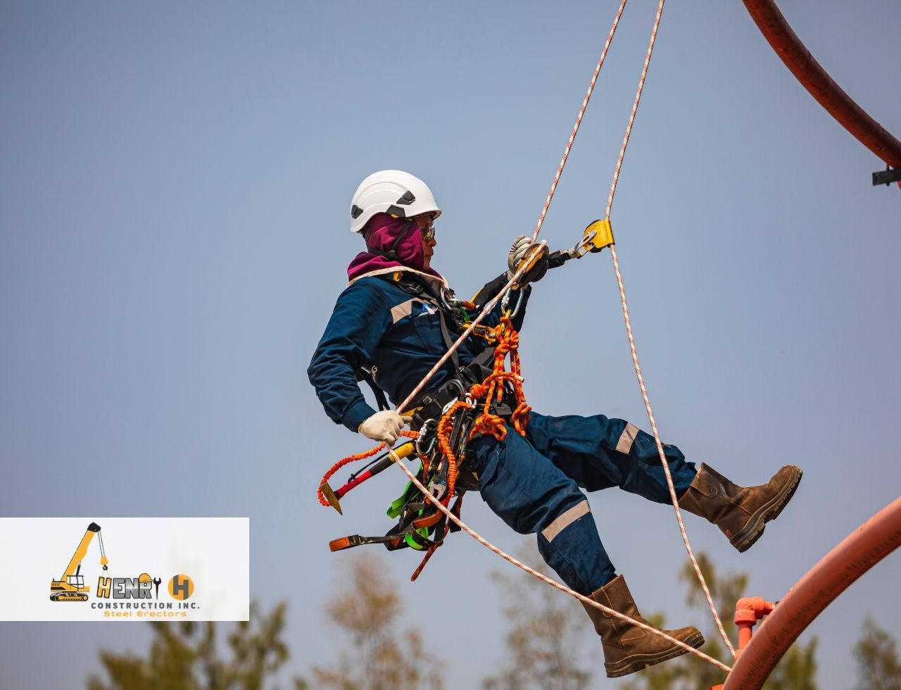 Worker learning how to inspect harness during steel erection safety training