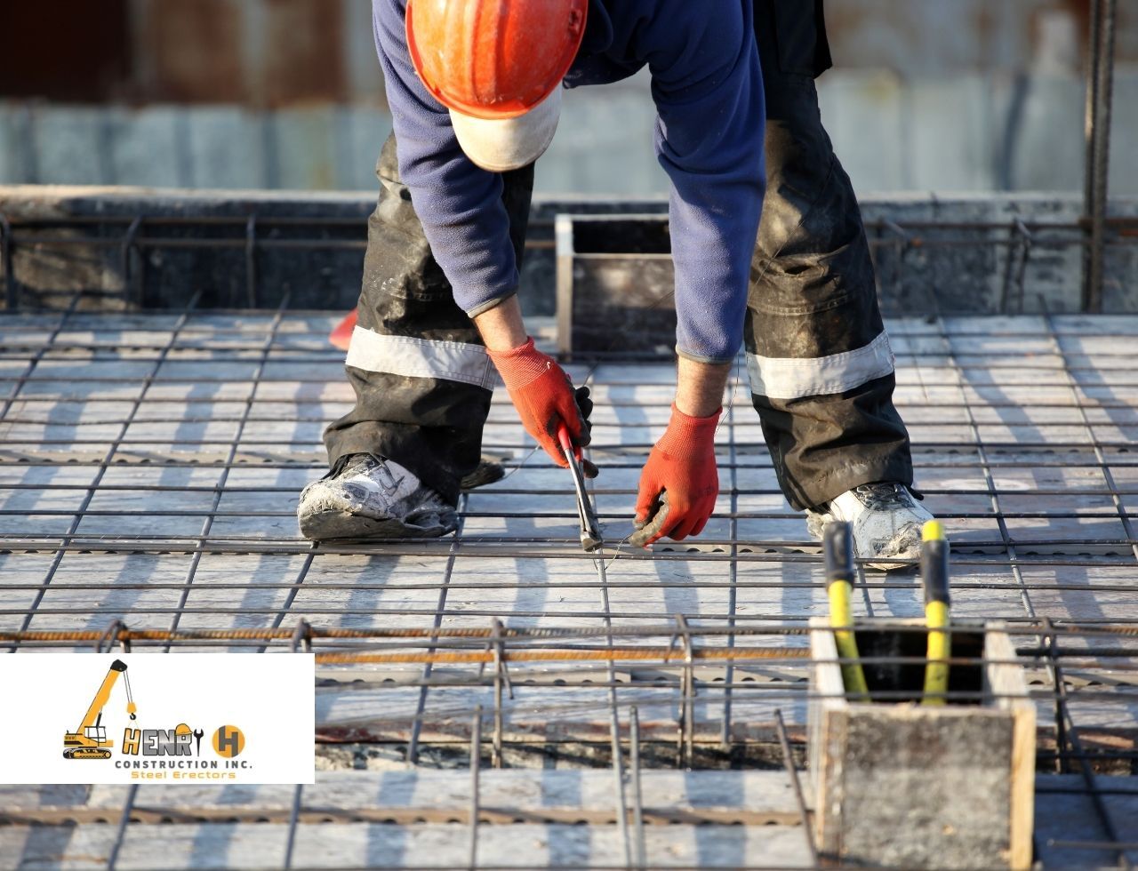 Construction crew installing steel beams on job site