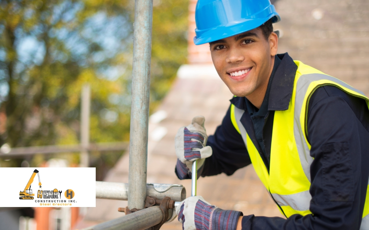 Workers following steel erection legal requirements with proper safety gear